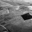 Oblique aerial view of Burnswark Roman Fort, seigeworks and other features.