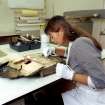 RCAHMS at Work: Miss A Wilson, conserving book.