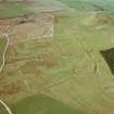 Oblique aerial view of Burnswark Roman Fort, siegeworks and other sites.