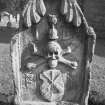 Humbie churchyard.
James Dobbie d.1679. Stylised leaves curling over top of stone. Hourglass between initials I D. Skull on crossbones. Tools of maltman on a shield between intials M M.