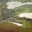 Lochmaben, oblique aerial view, taken from the NW, centred on the S part of the town, with St Mary Magdalene's church and burial ground and Lochmaben old castle and motte visible in the centre of the photograph.