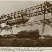 Sepia postcard insc: 'The "George Bennie" railplane at Milngavie, near Glasgow - picture shows car travelling at a height of 16 feet in the air. It is hung on rails, and can obtain a speed of 120 miles per hour. It is running over the L.N.E.R. track.'