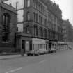 View from N showing WNW front of W block of warehouse with shop in foreground and numbers 8-12 Cambridge Street and numbers 202-212 Sauchiehall Street in background