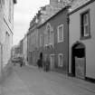 View from WNW showing N front of Masonic Hall with Carlyle House in background and part of numbers 3-5 Lodge Street in foreground