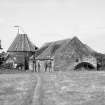 View from SW showing part of WNW and SSW fronts of mill with kiln in background