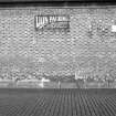 View of S (possible) goods shed showing enamel sign which is inscribed 'LION PACKING FOR ALL PURPOSES JAMES WALKER & CO LTD GLASGOW DEPOT 50 OSWALD ST'