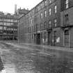 View from NW showing NNE front of numbers 7-13 Cochrane Street with part of warehouse in background
