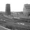 View from SSE showing SW and SE fronts of wooden cooling tower with part of retort house in right background