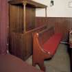 View of interior. Detail of pews, original pannelled oak pew to left
