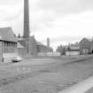 View from NW showing chimney and part of WSW front of factory with goods office (14 Catherine Street) on right