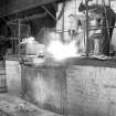Interior
View showing men working induction furnace