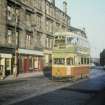 View from NW showing tram no 26 during last week of service with nos 541 - 557 on left