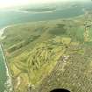 Oblique aerial view of Carnoustie golf course with the ranges and training area in the background, taken from the NE.