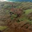Oblique aerial view of the crofting township and field-system with farmstead adjacent taken from the NE.
