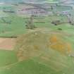 Oblique aerial view centred on the remains of the fort with village adjacent, taken from the W.