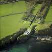 Oblique aerial view centred on the country house, walled gardens and stables, taken from the SE.