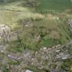 Oblique aerial view of Lennoxtown centred on the remains of the church and cemetery, taken from the SSW.