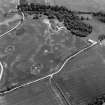 Oblique aerial view centred on the cropmarks of the timber hall, ring ditch, enclosures and pits at Mondobbo House, looking to the ENE.