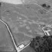 Oblique aerial view centred on the cropmarks of the timber hall, ring ditch, enclosures and pits at Mondobbo House, looking to the NNW.