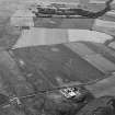 Oblique aerial view centred on Old Rattray farmstead with St Mary's Chapel adjacent, looking to the SSE.