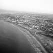 Oblique aerial view centred on Aberdeen beach, groynes and amusement park, looking to the S.