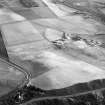 Oblique aerial view centred on the cropmarks of the unenclosed settlement, field system and rig at Braehead with the farmstead adjacent, looking to the SSW.