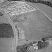 Oblique aerial view centred on the remains of the stone circle and henge at Broomend of Crichie, looking to the NNE.