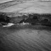 Oblique aerial view centred on the Sculptor's cave and Covesea caves, looking to the ESE.