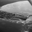 Oblique aerial view centred on the town and harbour of Burghead, looking to the SSE.
