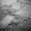 Oblique aerial view centred on the remains of the stone rows at the Hill O' Many Stanes, Clyth with cropmarks adjacent, looking to the SW.