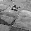Oblique aerial view centred on the cropmarks of the frost wedge polygons at Backwood Hill, looking to the SE.