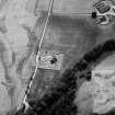 Oblique aerial view centred on the cropmarks of the Roman Temporary Camp, ring ditch and pits with Strathcathro Parish Church adjacent, looking to the SW.