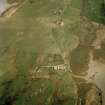 Oblique aerial view centred on the cottage with the manse and the remains of the church adjacent, taken from the WNW.