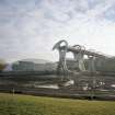 Digital copy of photograph of view from NW of empty canal basin, rotating boat lift, and visitor centre.