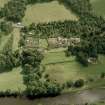 Oblique aerial view of Abbotsford centred on the country house with tea room, gardens and stables adjacent, taken from the NW.