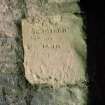 Detail of inscription at entrance to vaulted chamber at N end of range 'repaired in 1819'