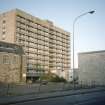 Aberdeen, Gilcomstoun Land (Chapel St and Skene St Section 2): View of Gilcomstoun Land tower block behind an older stone building and newer low-rise development.