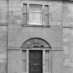 Scanned image of detail of front entrance and first floor window.