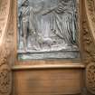 View of panel showing 'Death and Dr Hornbrook', on the back of the pedestal of the Robert Burns statue.