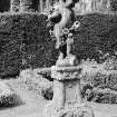 View of statue of cupid in garden at Carberry Tower.