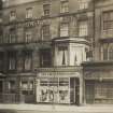 Historic photograph showing 21 Lothian Road, The County Hotel and Geo Cruttenden & Son shop.