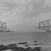 View of the Forth Bridge under construction seen from the West shore of South Queensferry.
