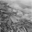 Denny, general view, showing Cruikshank and Co. Ltd. Denny Iron Works, Glasgow Road and Herbertshire Colliery.  Oblique aerial photograph taken facing east.
