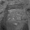 Cairnpapple Hill, photograph of excavation showing kerb stone of Period III cairn on SW.