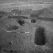 Cairnpapple Hill, photograph of excavation showing stone-hole 8, Beaker grave and Inhumation graves 3-4.