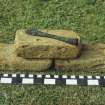 Three yellow bricks of Dutch type, part of the ship's cargo of 60,000, almost all of which have evidently been destroyed by abrasion. The iron tool is probably a bricklayer's line-pin. Scale in centimetres and inches.
