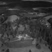 Ballindalloch Castle and Stables.  Oblique aerial photograph taken facing north.  This image has been produced from a print.