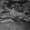 Ecclefechan, general view, showing High Street and Johnstone United Presbyterian Church.  Oblique aerial photograph taken facing north.  This image has been produced from a print.