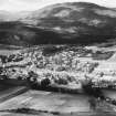 Kingussie and Creag Bheag.  Oblique aerial photograph taken facing north-west.  This image has been produced from a print.