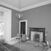 Interior, view of sitting room showing Jansen designed mahogany fireplace